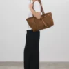 "Hunar Women's tan suede tote bag with knot detail and leather handles"