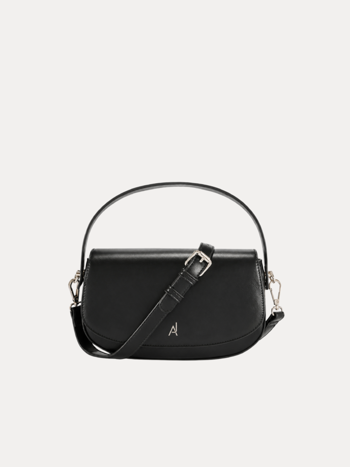 "Black premium leather saddle shoulder bag with curved handle, adjustable shoulder strap, and buckle detail - versatile women's crossbody bag"