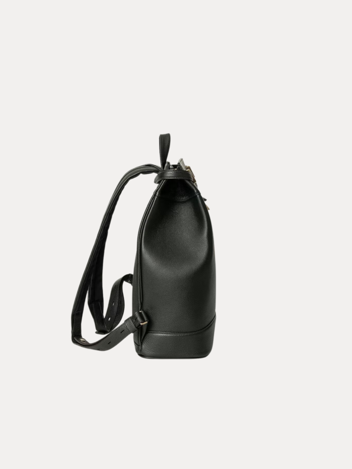 Close-up of the Noble backpack top latch closure and brass hardware detailing.