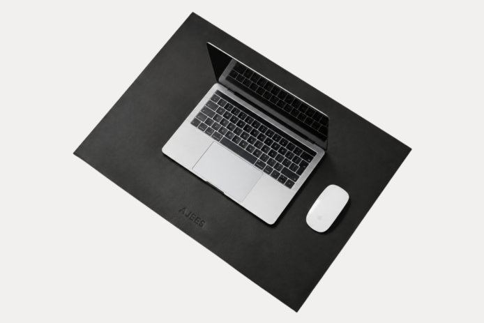 AJEES Premium Leather Desk Mat with laptop and mouse on a black leather office desk mat.