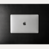 AJEES Premium Leather Desk Mat with laptop and mouse on a black leather office desk mat.