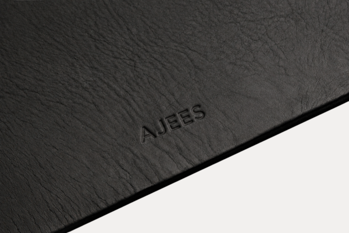 AJEES Premium Leather Desk Mat with laptop and mouse on a black leather office desk mat.