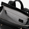 Close-up of the Noble backpack top latch closure and brass hardware detailing.