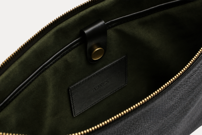 Black leather Late laptop bag with gold zipper and embossed AJEES logo