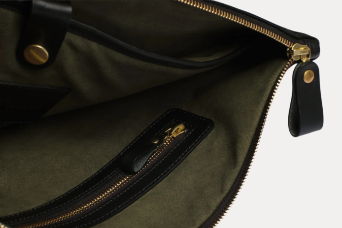Black leather Late laptop bag with gold zipper and embossed AJEES logo