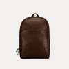 Image 1 (front view): Zenvik brown leather backpack with embossed AJEES logo, brass zippers and top carry handle