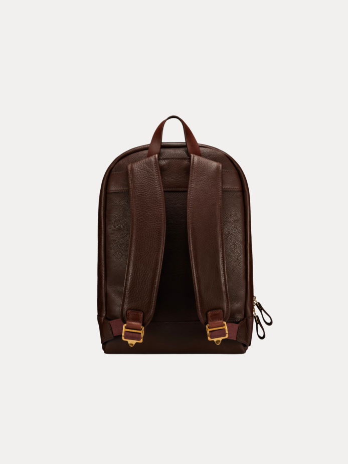 Image 1 (front view): Zenvik brown leather backpack with embossed AJEES logo, brass zippers and top carry handle